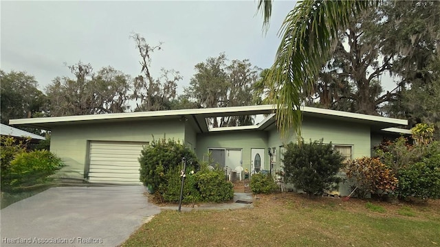 view of front of property with a garage and a front lawn