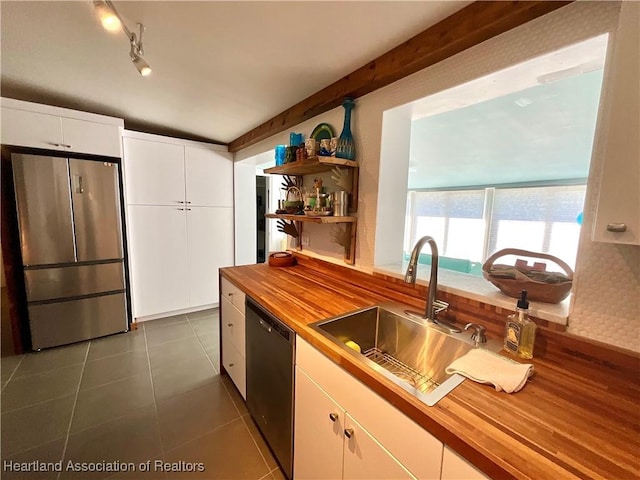 510 Lake June Rd, Lake Placid, FL 33852 - kitchen with white cabinetry, black dishwasher, stainless steel refrigerator, and wooden counters