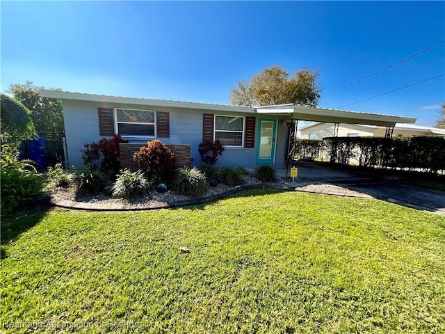 single story home featuring a carport and a front lawn