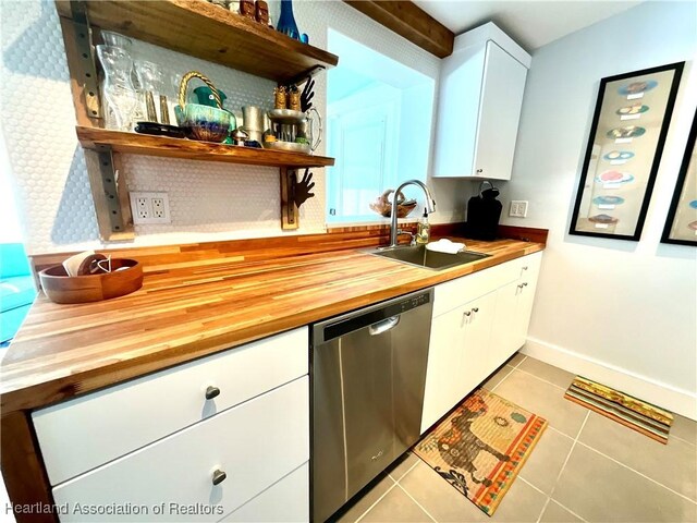510 Lake June Rd, Lake Placid, FL 33852 - kitchen with dishwasher, sink, white cabinets, wooden counters, and light tile patterned flooring