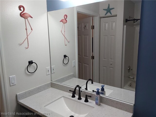 bathroom featuring a closet and vanity