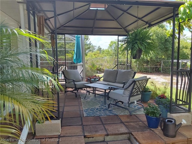view of patio / terrace featuring a carport, an outdoor living space, and fence