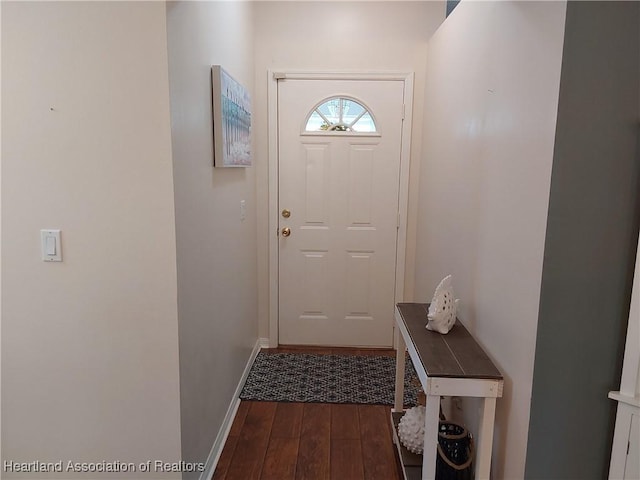 entryway with baseboards and dark wood-type flooring