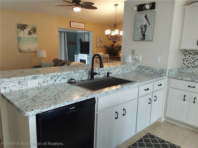 kitchen featuring ceiling fan with notable chandelier, a sink, dishwasher, white cabinets, and a peninsula