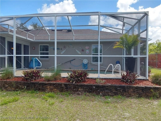 view of side of home with a patio, a lanai, and a shingled roof