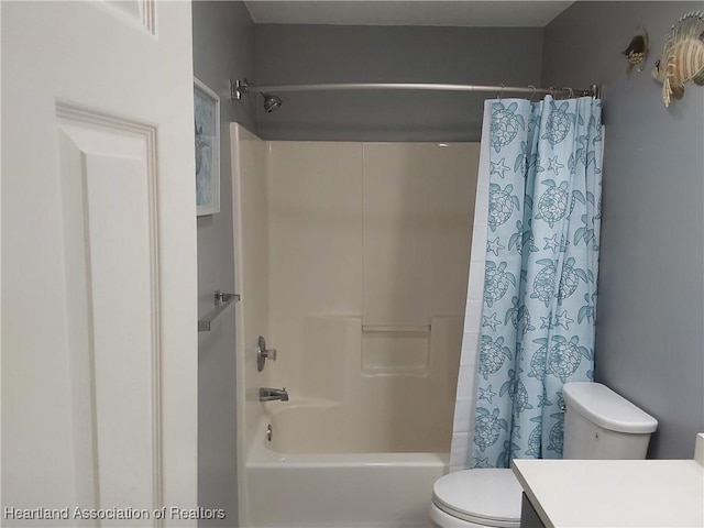 bathroom featuring toilet, vanity, and shower / bath combo