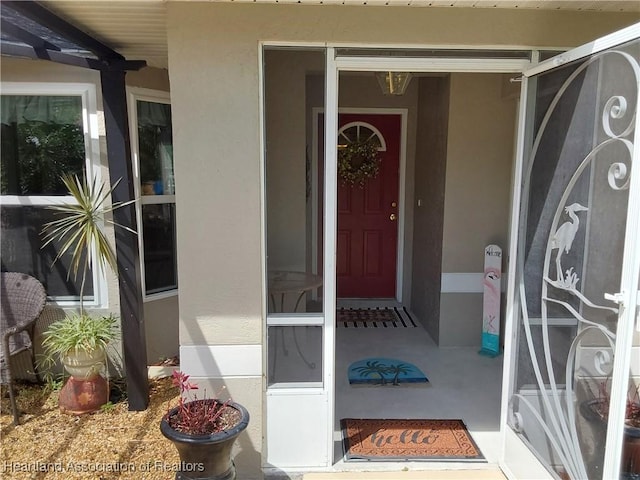 property entrance with stucco siding