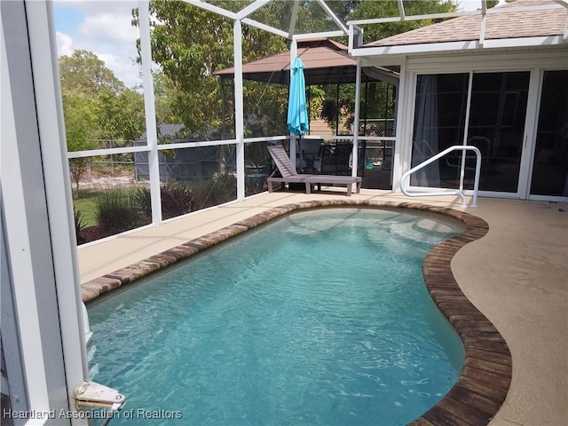 pool featuring a lanai and a patio area