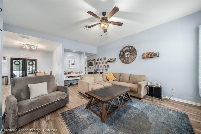 living room with wood-type flooring, ceiling fan, and french doors