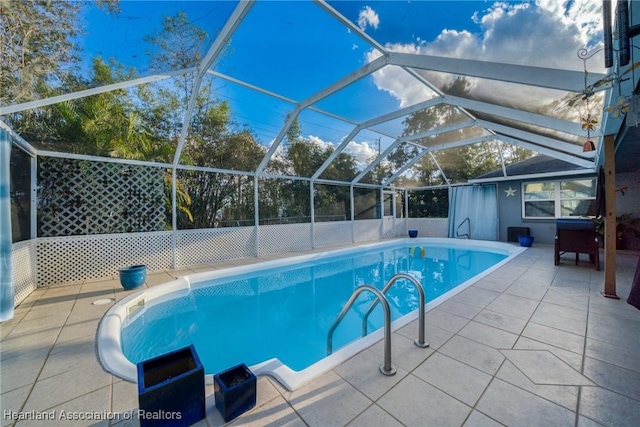 view of pool featuring a patio area and glass enclosure