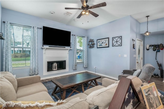 living room with hardwood / wood-style flooring, ceiling fan, and plenty of natural light