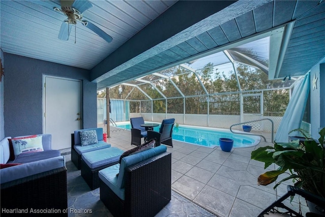 view of patio / terrace featuring a lanai, outdoor lounge area, and ceiling fan