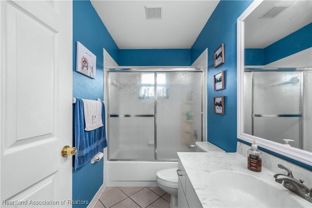 full bathroom with toilet, tile patterned floors, bath / shower combo with glass door, and vanity