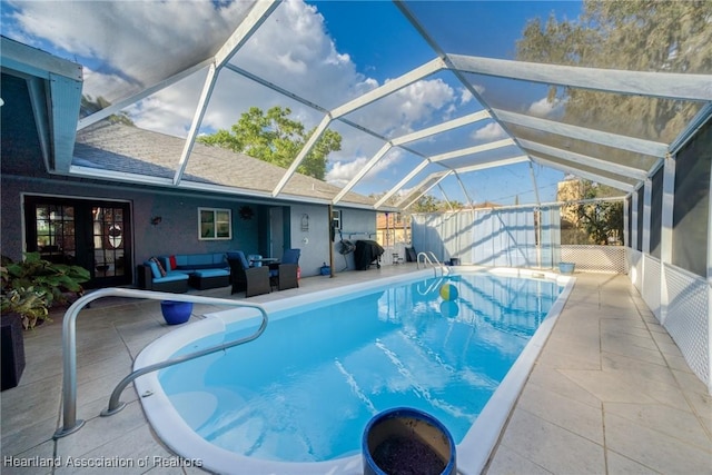 view of pool featuring a lanai, an outdoor hangout area, and a patio