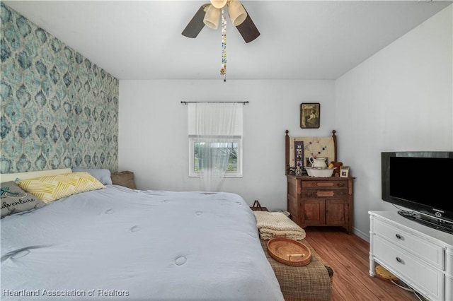 bedroom featuring hardwood / wood-style flooring and ceiling fan