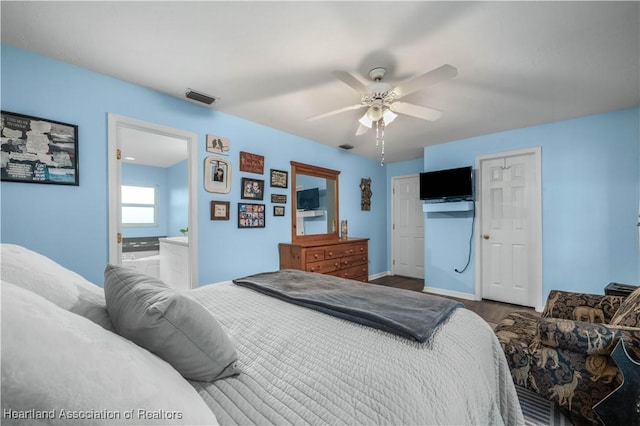 bedroom featuring wood-type flooring, a closet, ceiling fan, and ensuite bathroom