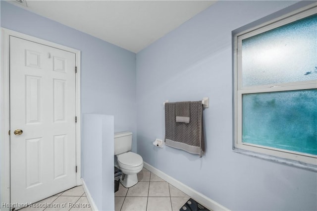 bathroom with toilet and tile patterned flooring