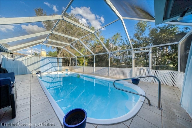 view of swimming pool with a patio area and glass enclosure