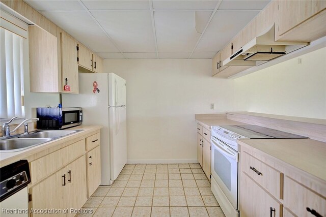 5544 Matanzas Dr, Sebring, FL 33872 - kitchen with white appliances, light brown cabinets, a sink, light countertops, and a drop ceiling