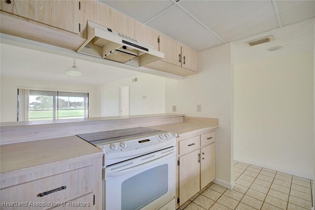 5544 Matanzas Dr, Sebring, FL 33872 - kitchen with electric range, light brown cabinetry, light countertops, under cabinet range hood, and light tile patterned flooring