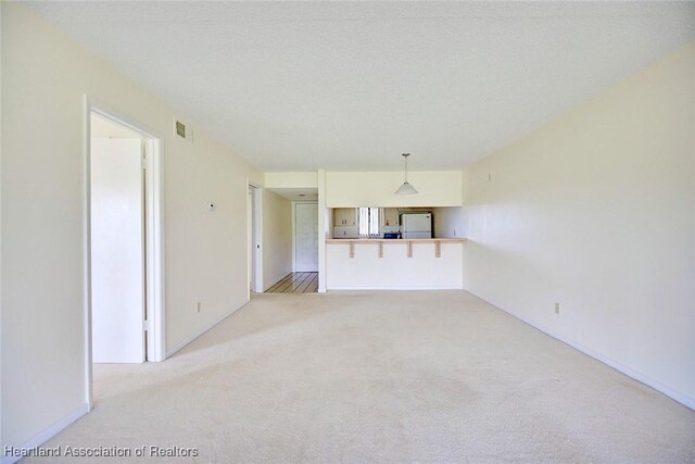 5544 Matanzas Dr, Sebring, FL 33872 - unfurnished living room with carpet floors and baseboards