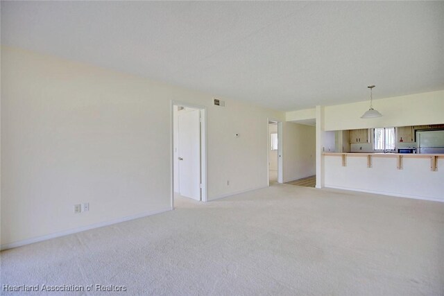 5544 Matanzas Dr, Sebring, FL 33872 - unfurnished living room with light carpet and baseboards