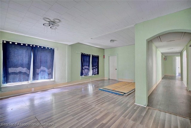 empty room with plenty of natural light and wood-type flooring