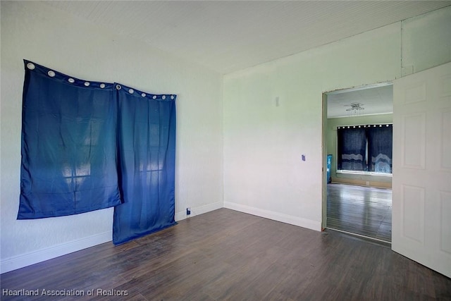 empty room featuring dark hardwood / wood-style flooring