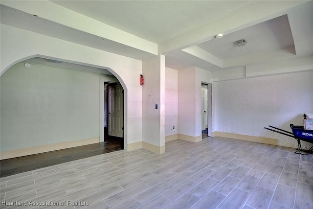 empty room featuring a tray ceiling