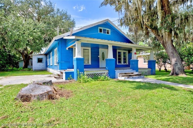 bungalow with a porch and a front yard