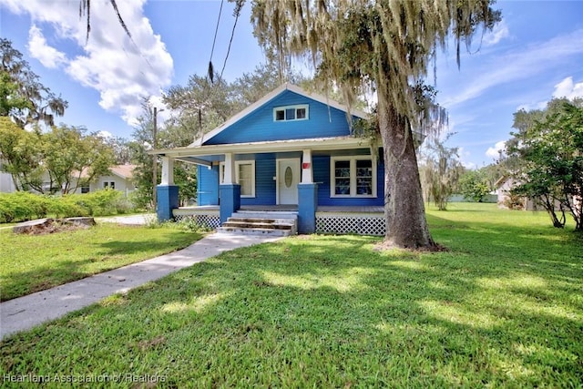 bungalow-style home featuring a porch and a front lawn