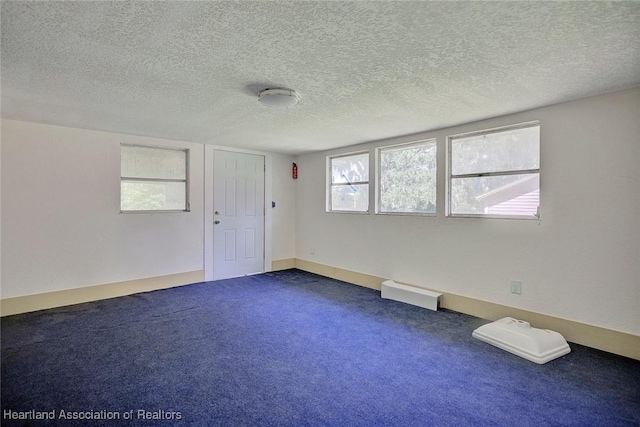 empty room featuring carpet floors and a textured ceiling