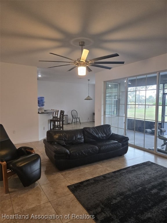 tiled living room with ceiling fan