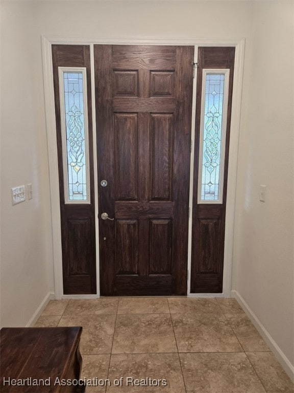 foyer entrance with baseboards