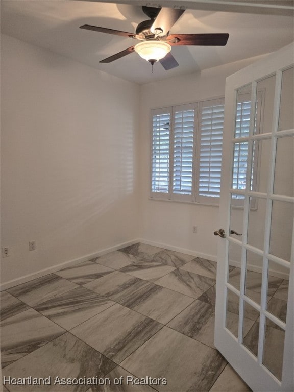 unfurnished room featuring ceiling fan, baseboards, and french doors