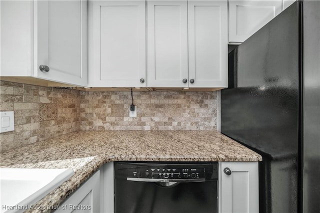 kitchen with backsplash, black appliances, white cabinets, sink, and light stone counters