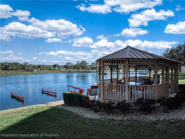 dock area featuring a yard and a water view