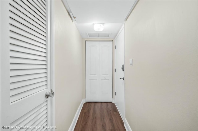 hallway with dark hardwood / wood-style flooring