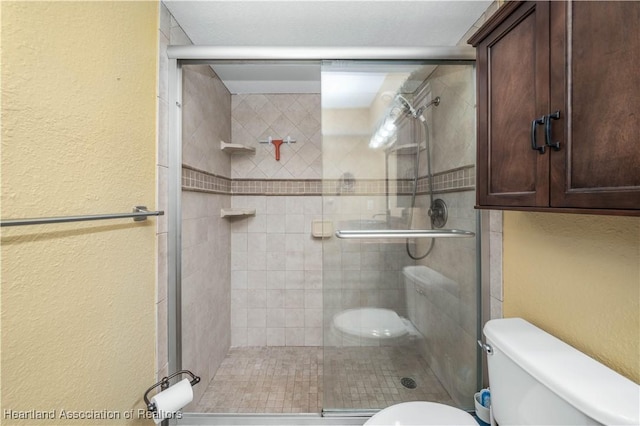 bathroom featuring an enclosed shower and toilet