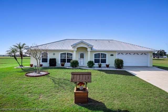 view of front of house with a garage and a front yard