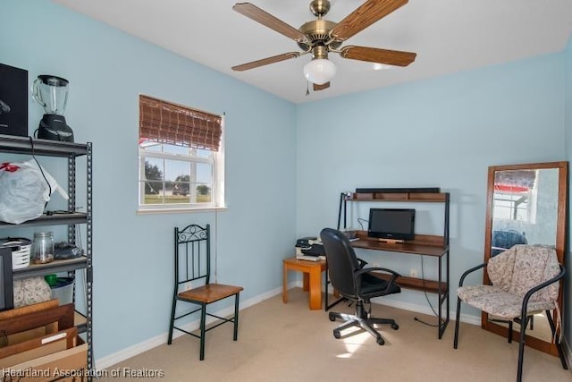 carpeted office space with ceiling fan