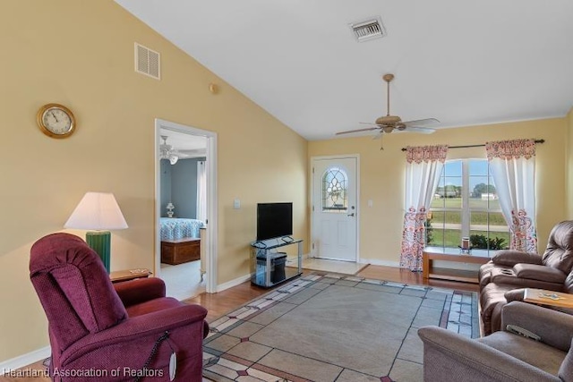 living room with ceiling fan and high vaulted ceiling