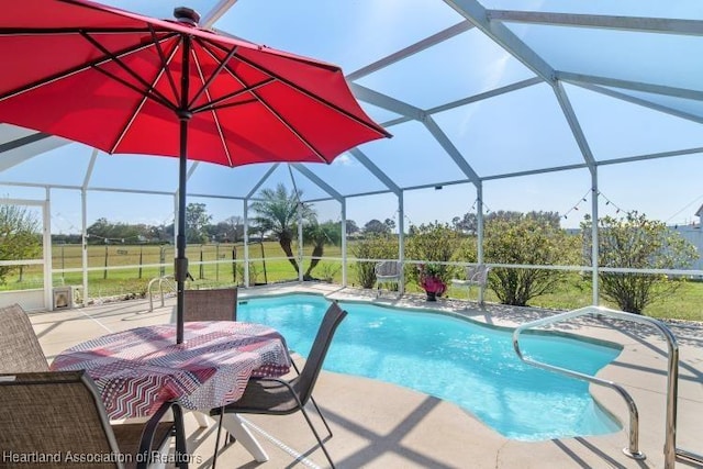 view of pool featuring a lanai and a patio