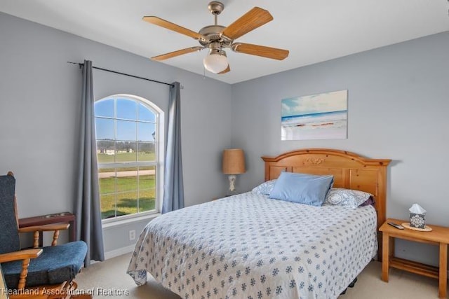 bedroom featuring ceiling fan and light carpet