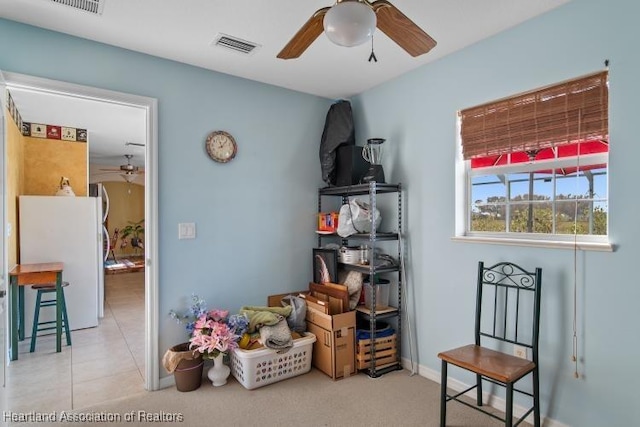 interior space with ceiling fan