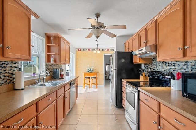 kitchen with tasteful backsplash, appliances with stainless steel finishes, sink, and light tile patterned floors