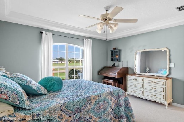 carpeted bedroom with crown molding and ceiling fan