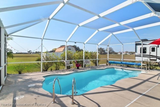 view of pool with a lanai and a patio