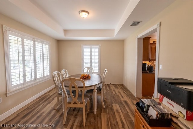 112 Wild Duck Pt, Lorida, FL 33857 - dining room featuring a raised ceiling and wood finished floors