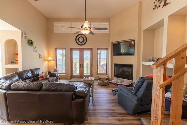 112 Wild Duck Pt, Lorida, FL 33857 - living area with a ceiling fan, wood finished floors, a towering ceiling, french doors, and a fireplace